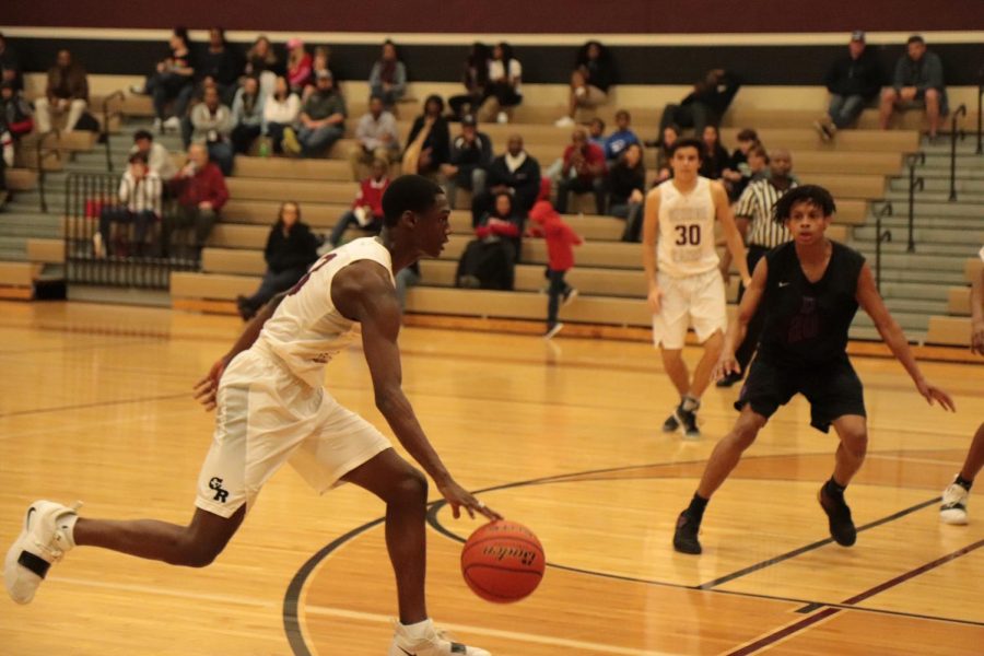 A.D. Harris (11) dribbling down the court and passing defenders