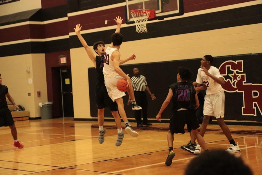 Caden Cook (11) Jumping to pass the ball and get pass a defender