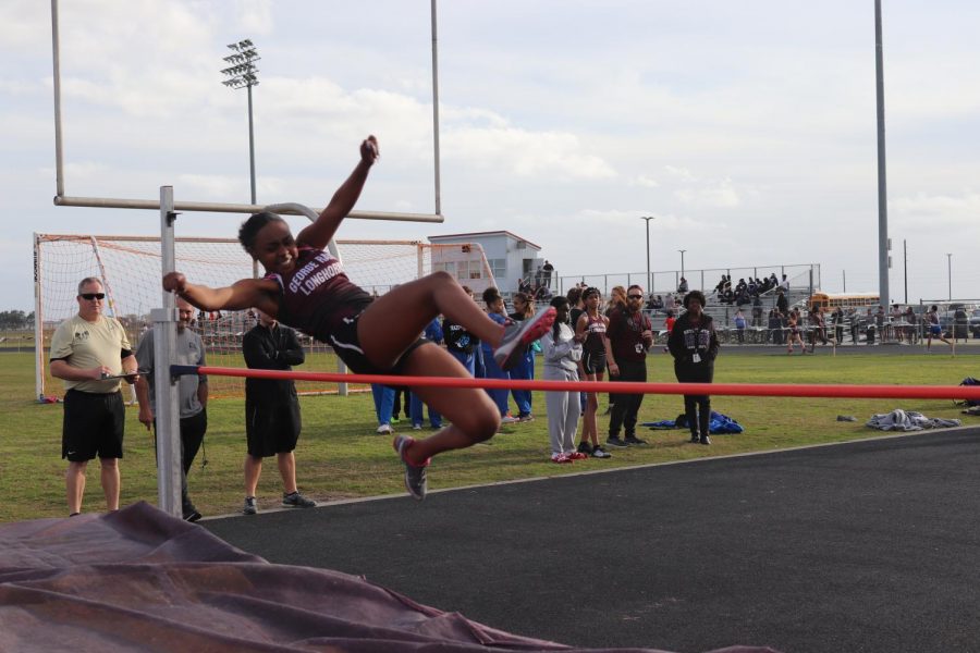 Ariel McGee (10) is jumping over the bar in high jump.