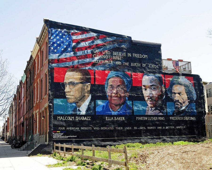 Mural on the wall of row houses in Philadelphia. The artist is Parris Stancell, sponsored by the Freedom School Mural Arts Program. Left to right; Malcolm Shabazz (Malcolm X), Ella Baker, Martin Luther King, Frederick Douglass. The quote above the pictures,We Who Believe in Freedom Cannot Rest, is from Ella Baker, a founder of SNCC (Student Non-Violent Coordinating Committee), a civil rights group. which amongst other contributions, helped to coordinate Freedom Ridesin the early 1960s.