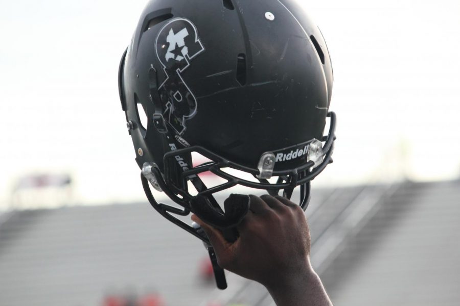 A helmet being held high signifies a good game is about to happen.