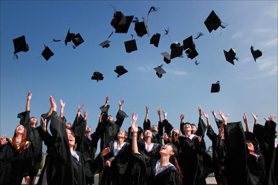 Seniors are celebrating the fact that they just graduated by throwing their caps in the air.