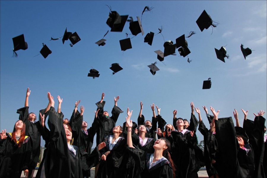 Seniors+are+celebrating+the+fact+that+they+just+graduated+by+throwing+their+caps+in+the+air.