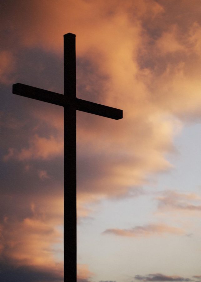 clouds blowing over a cross.