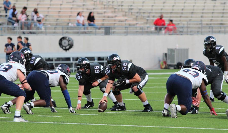 Offensive players No. 66 Grant Poss (10) and No. 52 Parker Galvan (11) are awaiting the start whistle from the referee to hand off the ball to No. 9 KJ White (11).