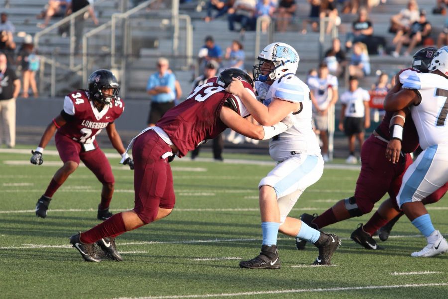 No. 99 Jack Lovelace (12) keeping Brazoswoods defensive line away from his teamates to give the players a pathway to the end zone.