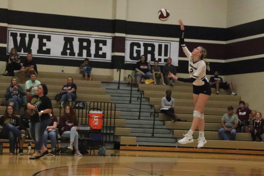 Avery Shimaitis going for a jump serve hoping to gain a point.