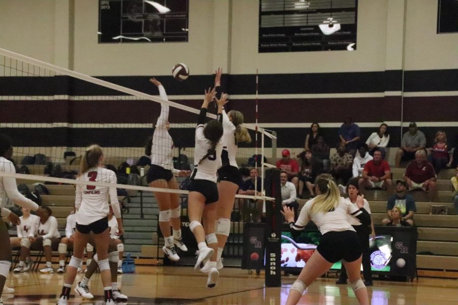 Riley Steubing and Alexandra Sczech jumping up to block a spike.