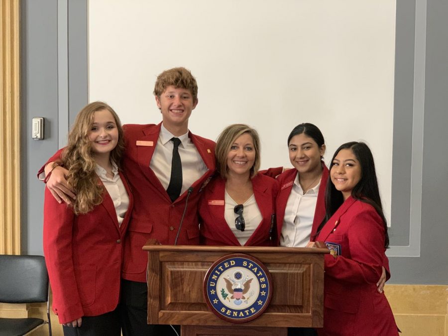 (Left) Emma Heintz, Tanner Hill (11), April Schmidt (11), Asma Shahzad (12), and Kaitlyn Rodriguez (11) standing at the podium where they met Senator Ted Cruz during their Texas Tuesday Coffee with Cruz.