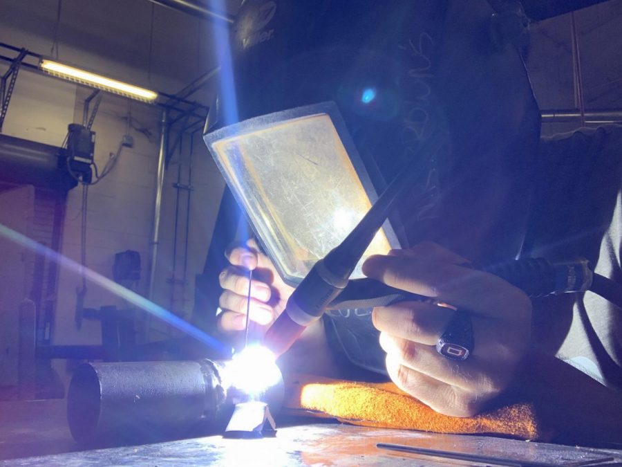 Leo Diaz is welding 2 pipes together for his project.