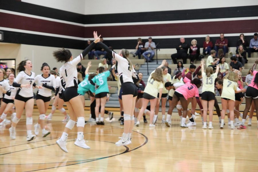 (No. 1) Alex Tennon and (No. 2) Avery Shimaitis get their team hyped up before their game.