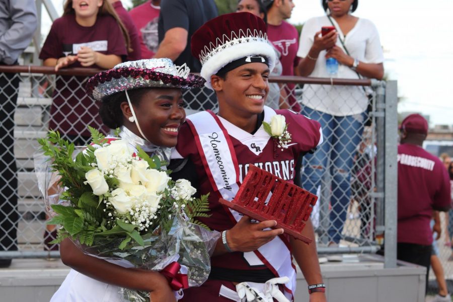 Victoria Adigun (12) and Andre Falkquay (12) holding up Mr. Toups famous Believe sign as Toups takes their photograph. 