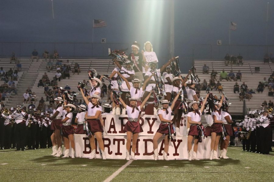 Teacher Homecoming court, Mr. Siegmund and Ms. Hydo have the high power to be on top of the tenth anniversary birthday cake, surrounded by the GRHS Larriettes. 