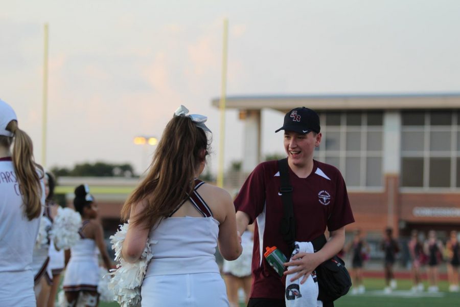 Trainer wishing good luck to one of our senior cheerleaders Devin Walker before the game starts 