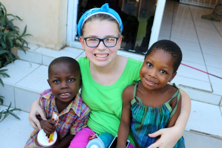 Nicole dencklau with Haitian orphans,Jerry and Esther during her trip to Haiti.