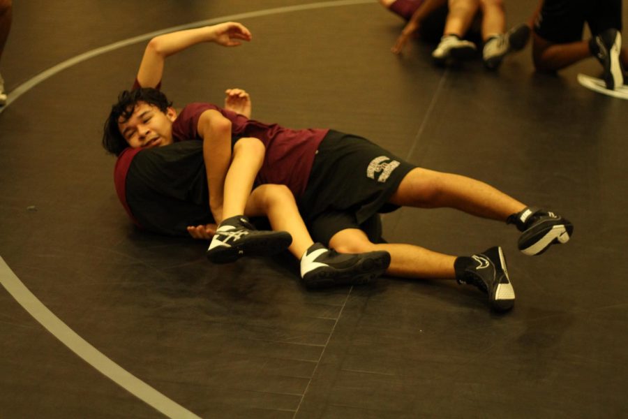 Colby Duran gaining the upper hand and pinning his opponent. 