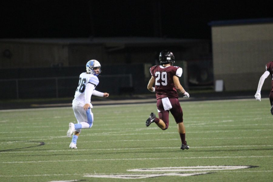 Wyatt Jones (10) running past opponent to catch incoming ball 