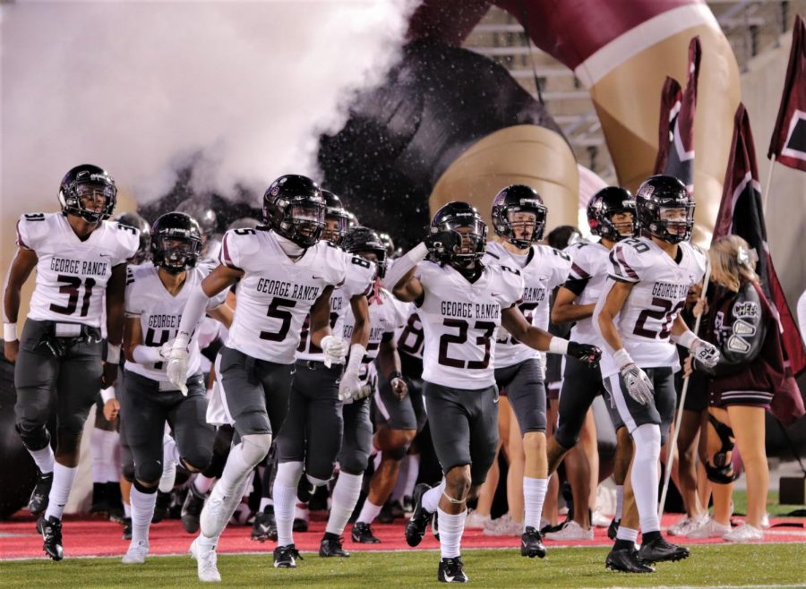 The Longhorn varsity football players enter the arena with great energy after halftime as they are winning against Humble. 