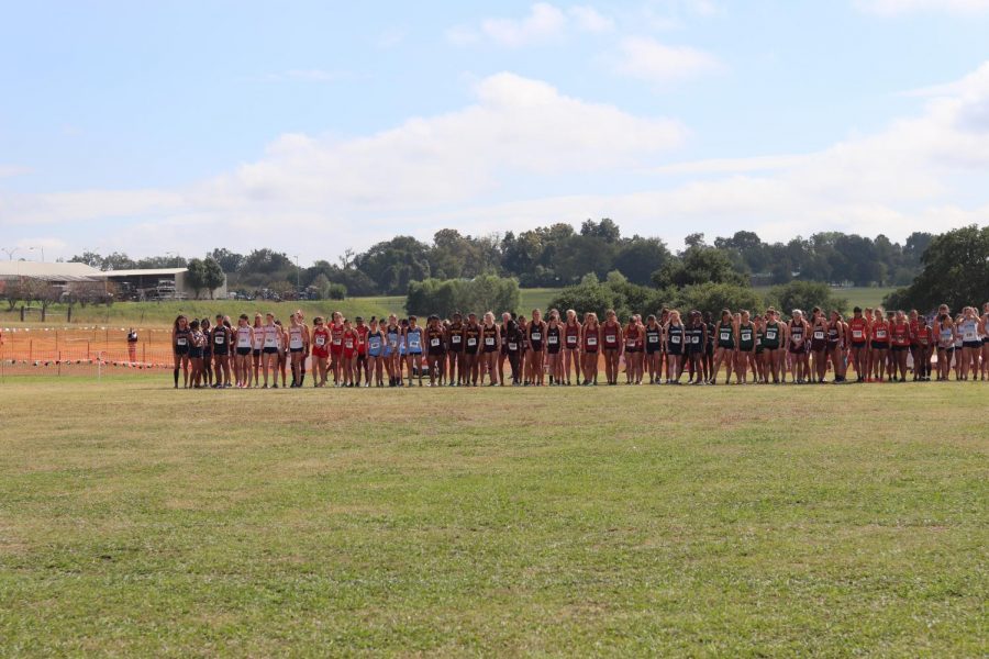 Before the race begins, the George Ranch Varsity Girls are stepping to the line, getting ready for the gun to go off.