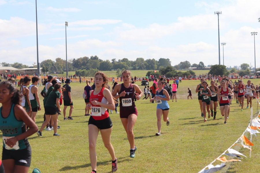 Brooke Johnson (12), is on her 2nd lap out of 3, pushing through to pass the girls ahead of her.