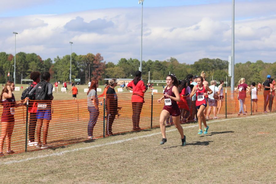 Alyssa Hiekkila (12), finishes strong as she passes another girl before the end.