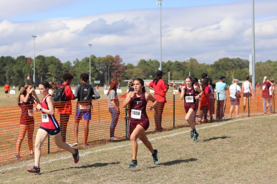 Sydney Delgado (12) and Madison Haldiman (9), competed to the finish line as they worked together to pass up more girls.