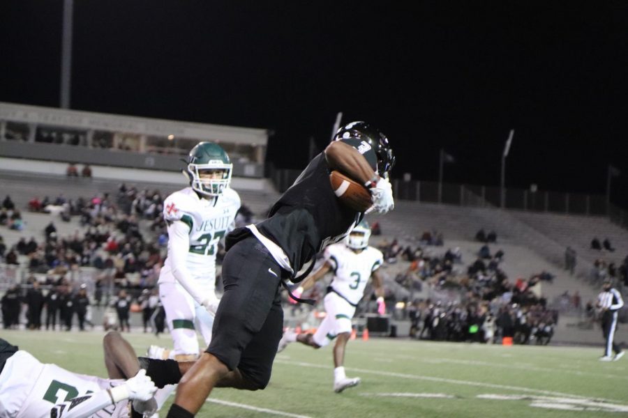 No. 3, Andre Falkquay(12), runs down the field with the ball trying not to get tackled by Strake's defense.