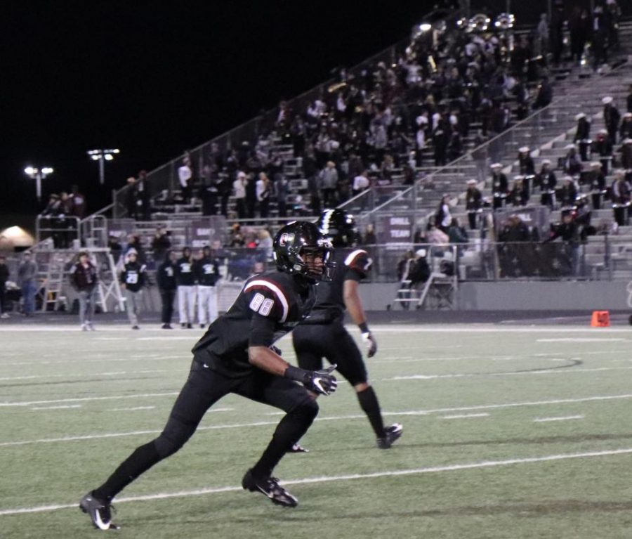 No. 88, Jaden Adams(12), lunges at Strake's corner to prevent him from getting past. 