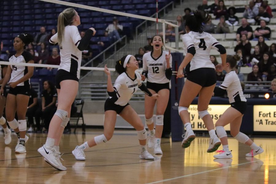 After a tough set, No. 1 Alex Tennon (11) gets her groove back with a solo block against Pearland's middle hitter. 
