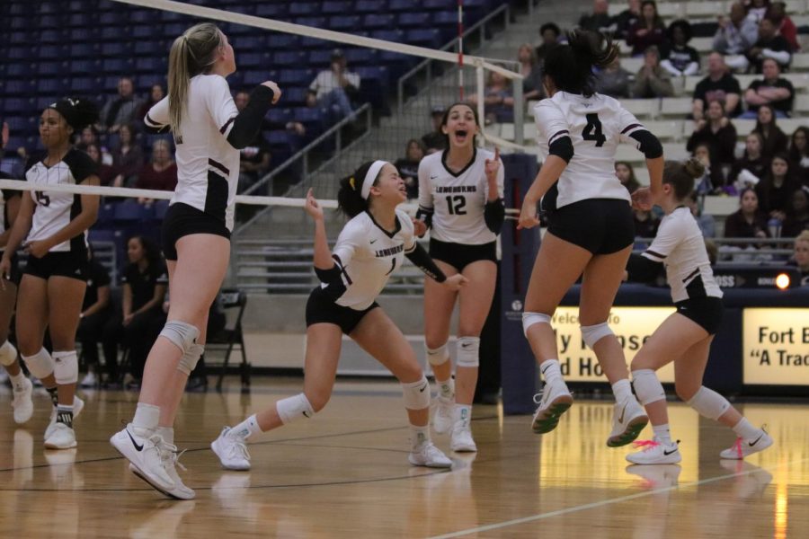 After a tough set, No. 1 Alex Tennon (11) gets her groove back with a solo block against Pearlands middle hitter. 