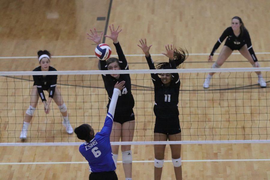 No. 14 Allie Sczech (10), and No. 11 Kyndall Cole (11) moments before blocking Clearlakes middle hitter. No. 1 Alex Tennon (110 and No. 12 Riley Steubing (10 are ready to dig the ball if needed. 