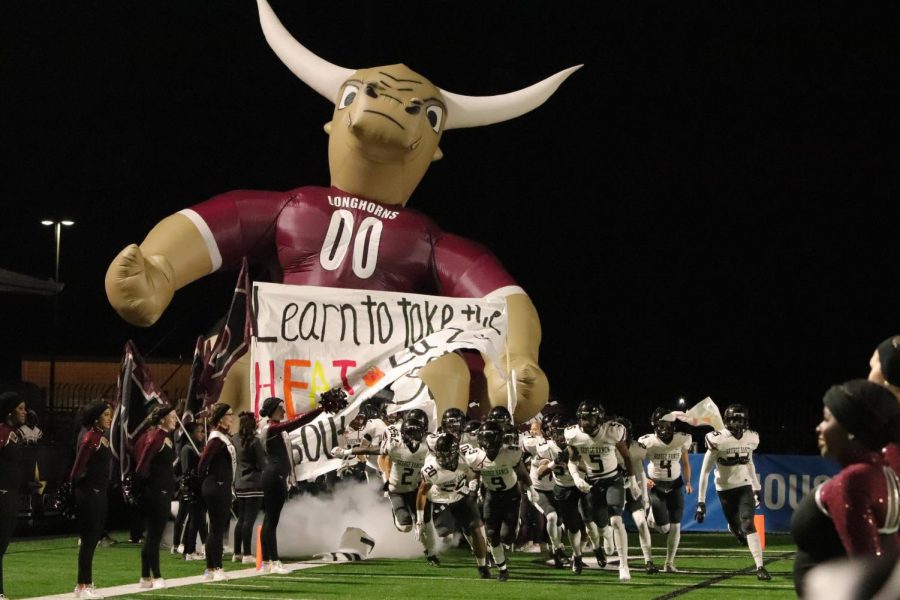 George Ranch football runs through the tunnel to kick off the first quarter.