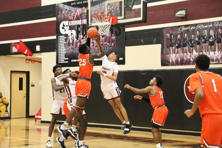 No. 14, Jullian Camper(11), blocks No. 25's jump shot.