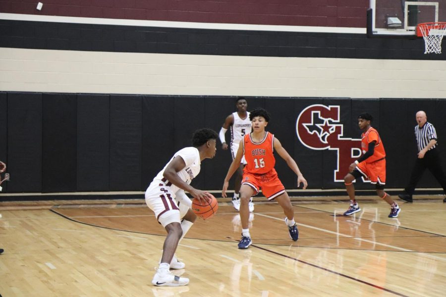 No. 1, Stephen Woods(11), attempts to pass the ball while Bush tries to block to pass.