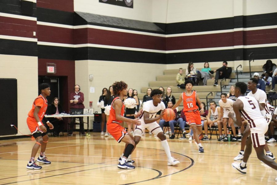 No. 1, Stephen Woods(11), gets the ball passed to him while No. 24 tries to block the pass.