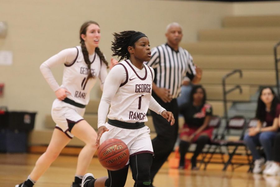 No. 1 Jaedyn Dunn (12) is fulfilling her point guard duties by running the offense and looking for an open pass to her center player. 