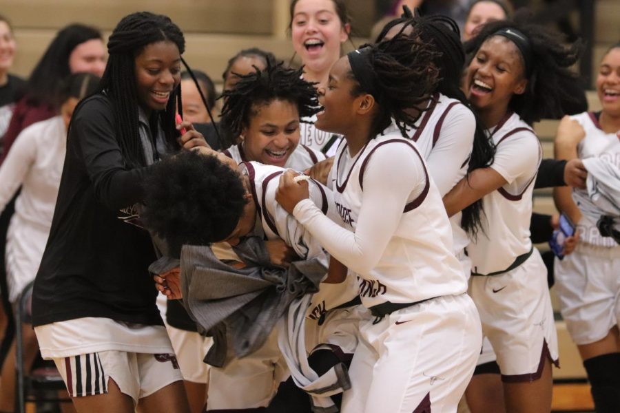 No. 12 Nyah Swafford (12) being swarmed by her excited team after the game ended with a final score of 71-38.