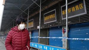 A Man with a mask walking the empty streets of Wuhan.