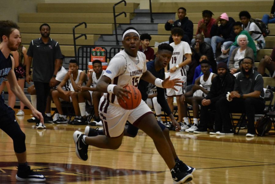 No. 35 Zion Harper (9) striving down the court as hes looking for an open teammate to pass the ball to.