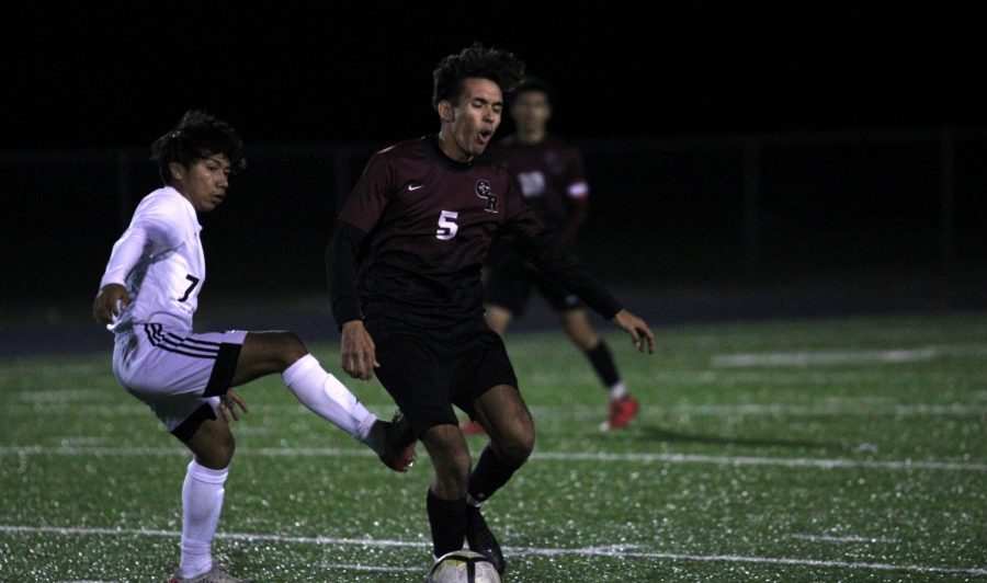 No. 5 Martin Nunez (12) trying to maintain possesion of the ball as his face shows his exhaustion.