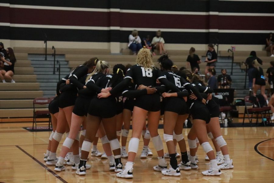 Allie Sczech (11) and her team doing their team chant before going onto the court to win their game.