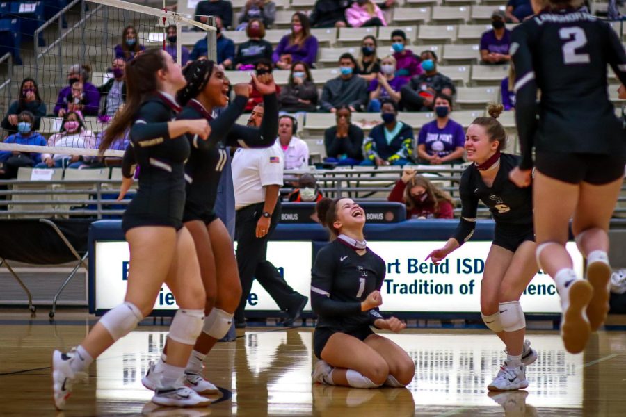 No. 1 Alex Tennon (12) and her team filled with true happiness after winning the fourth set of the match which ended up tieing the two teams.
