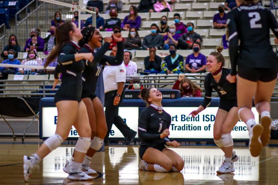 No. 1 Alex Tennon (12) and her team filled with true happiness after winning the fourth set of the match which ended up tieing the two teams.