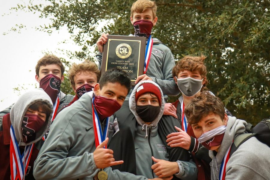 The varsity boys lift up their teammate Travis Moorey (9) in celebration of another win for the Longhorns.