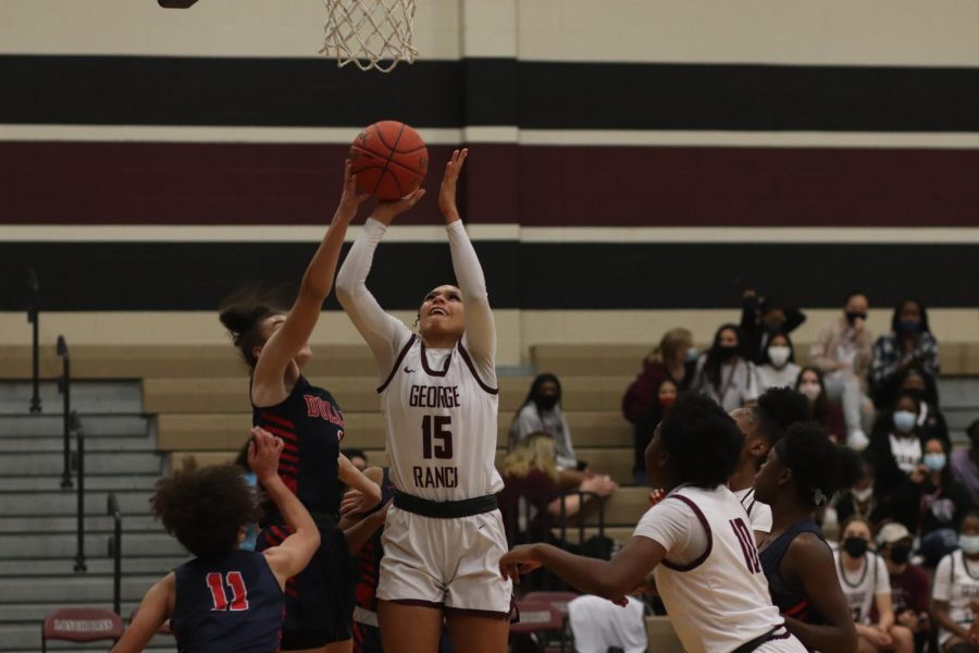 No. 15 Gabby Owens (12) going in for an easy layup to help gain more points for the Longhorns.