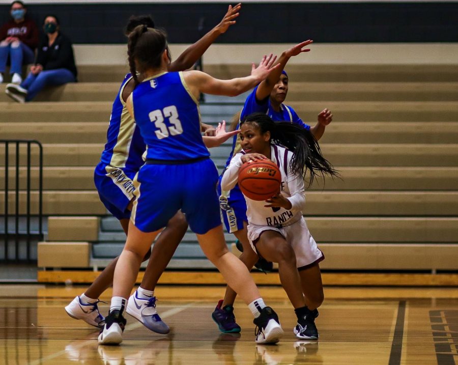 No. 3 Savannah Velasquez (11) using her height as an advantage to dribble the ball under and through Elkins' defensive team.