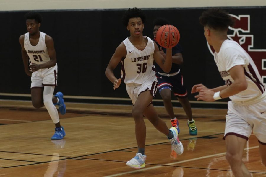 No. 30 Jamey Beston (10) passing the ball over to Jullian Camper (12) as they attempt to make a fast-break score.