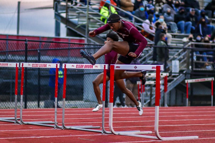Bryce McCray (12) competing in the boys 110m hurdle race alongside his teammate Shane Gardner (11). McCray finished first with a time of 14.60 seconds, and Gardner second with a time of 15.06.