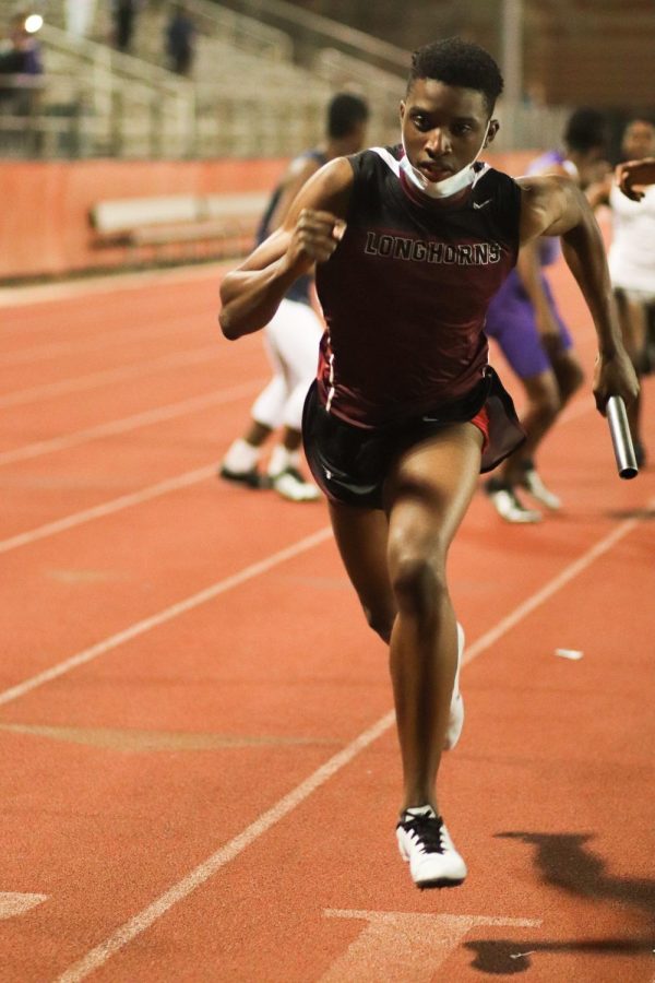 Michael Okoroha (11) was running the last leg of the 4x4. He attempted to catch up to the other team in front of him. 