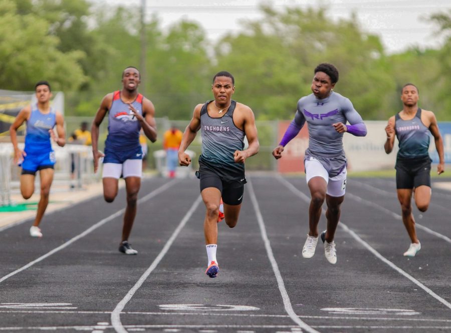Grant Celestine (12) won the district title in the boys 400-meter dash with a new personal record time of 49.89.